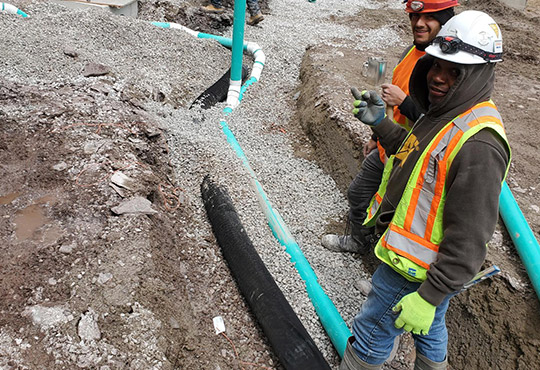 Cadetta Drain Workers on Site